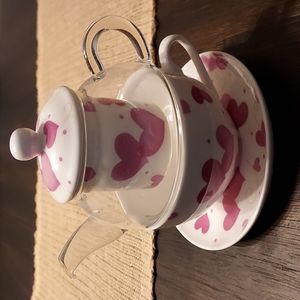 Teacup with tea pot, tea infuser.